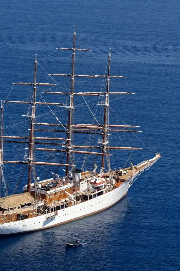 Aerial view of a grand tall ship sailing in the clear blue waters of the Aegean Sea.